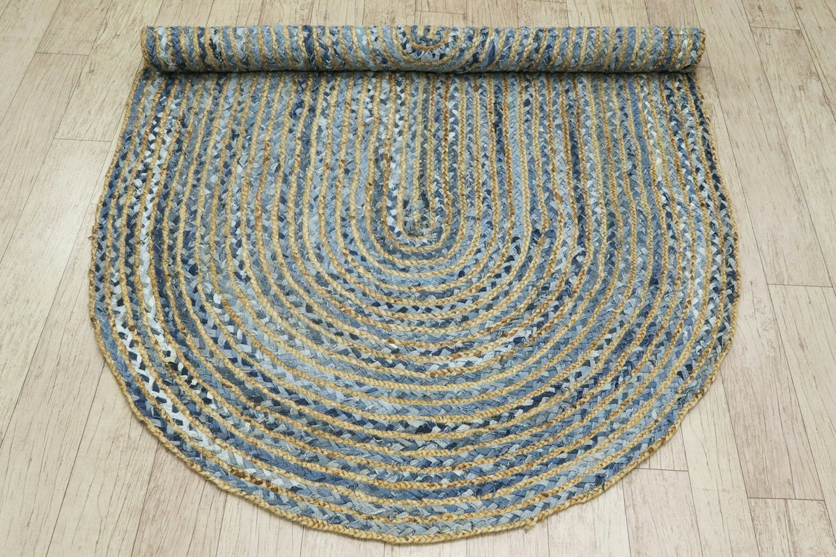 A semi-circular rug with braided texture and woven textures